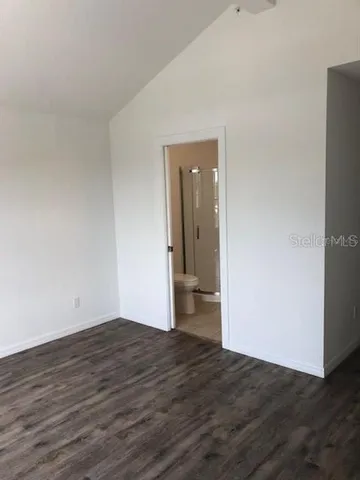 a view of a room with wooden floor