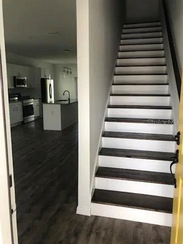 a view of entryway and hall with wooden floor