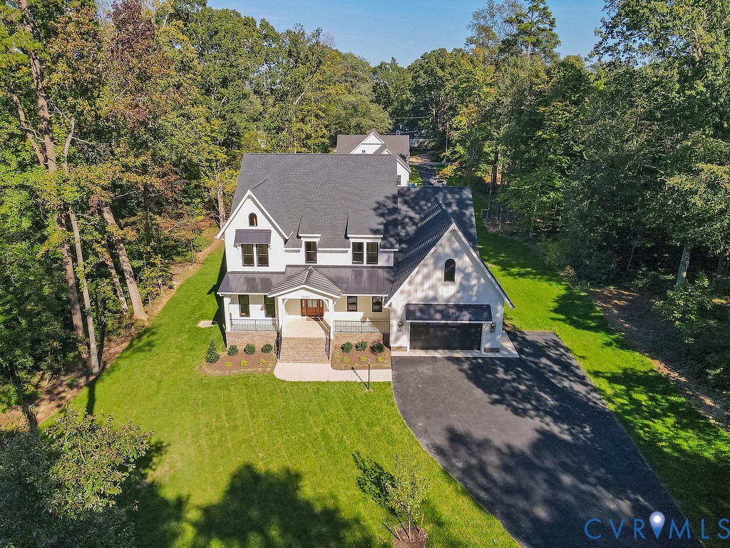 a aerial view of a house with swimming pool garden and patio