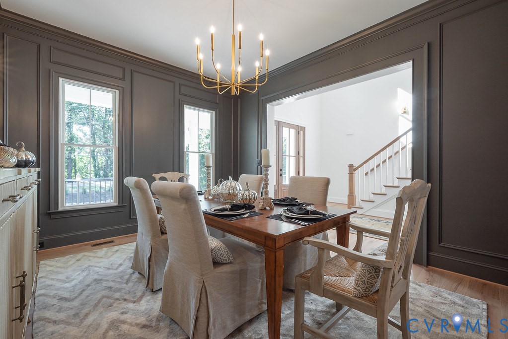 1509 Buford Road North Chesterfield, VA 23235 - Photo 7 of 50 a view of a dining room with furniture a chandelier and wooden floor