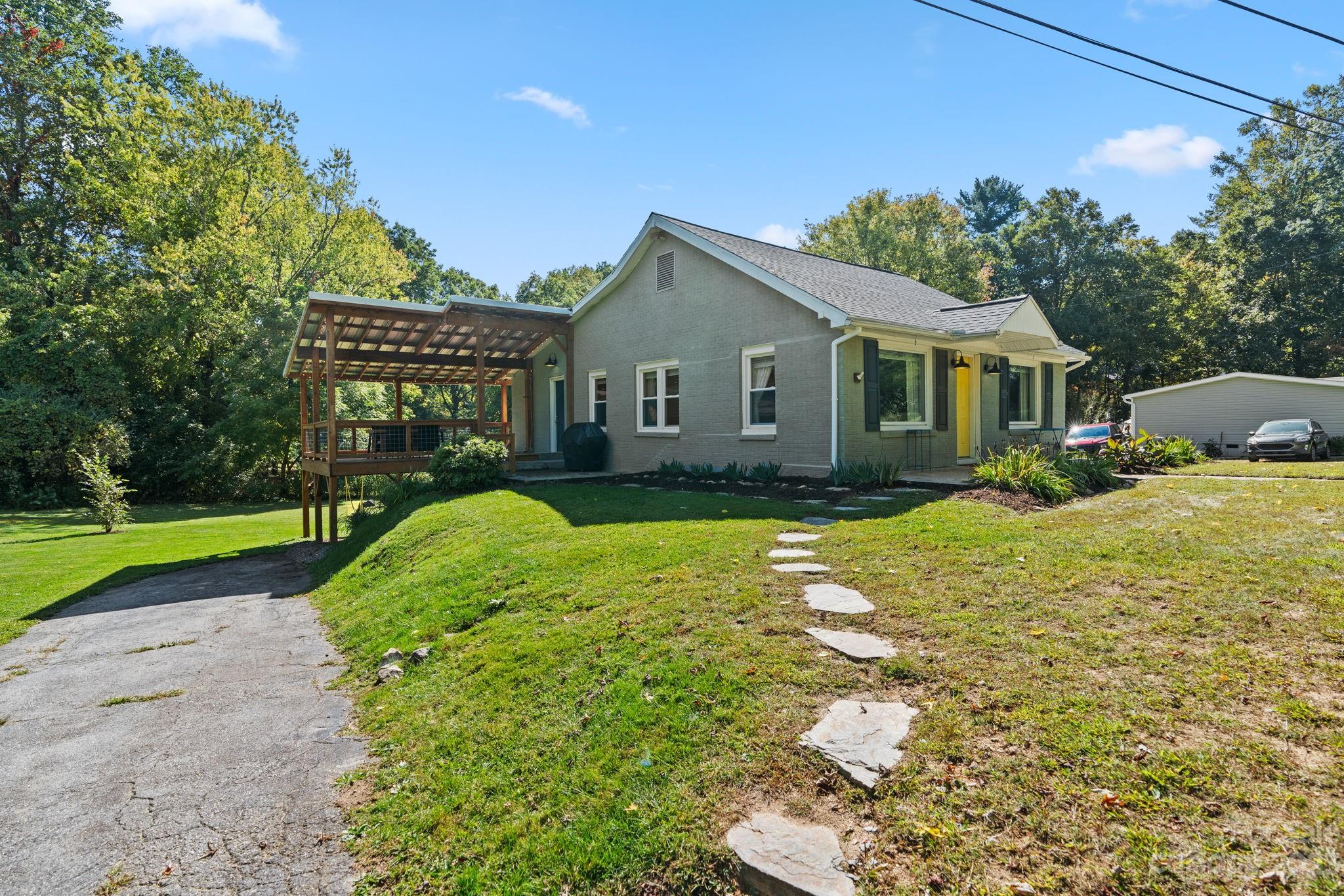 35 Old Fort Road Fairview, NC 28730 - Photo 4 of 30 a view of a house with a yard and potted plants