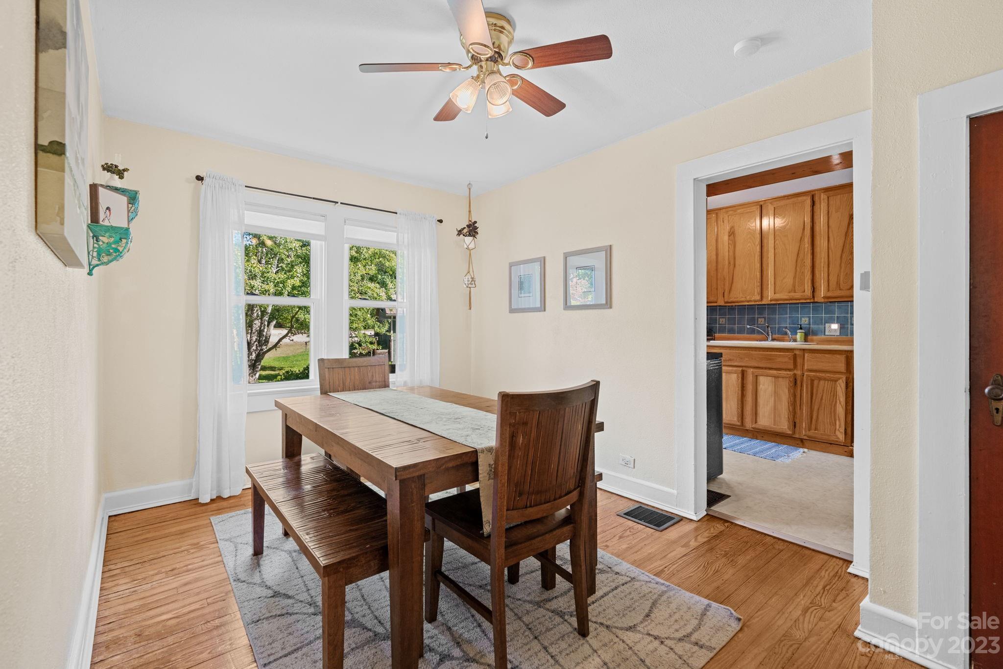 35 Old Fort Road Fairview, NC 28730 - Photo 10 of 30 a view of a dining room with furniture window and wooden floor