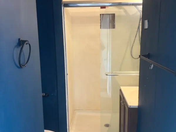 a bathroom with a glass shower door