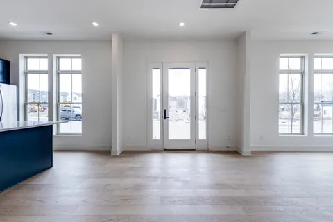 a view of a kitchen with a sink and a large window