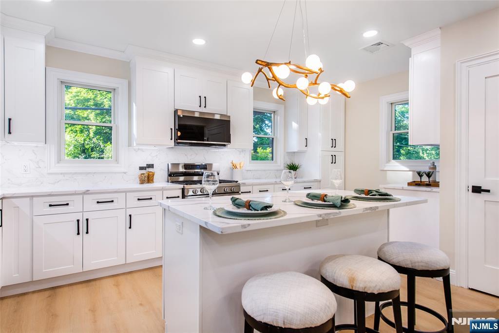 145 Grove Street Mahwah, NJ 07430 - Photo 7 of 30 a kitchen with a sink cabinets and window