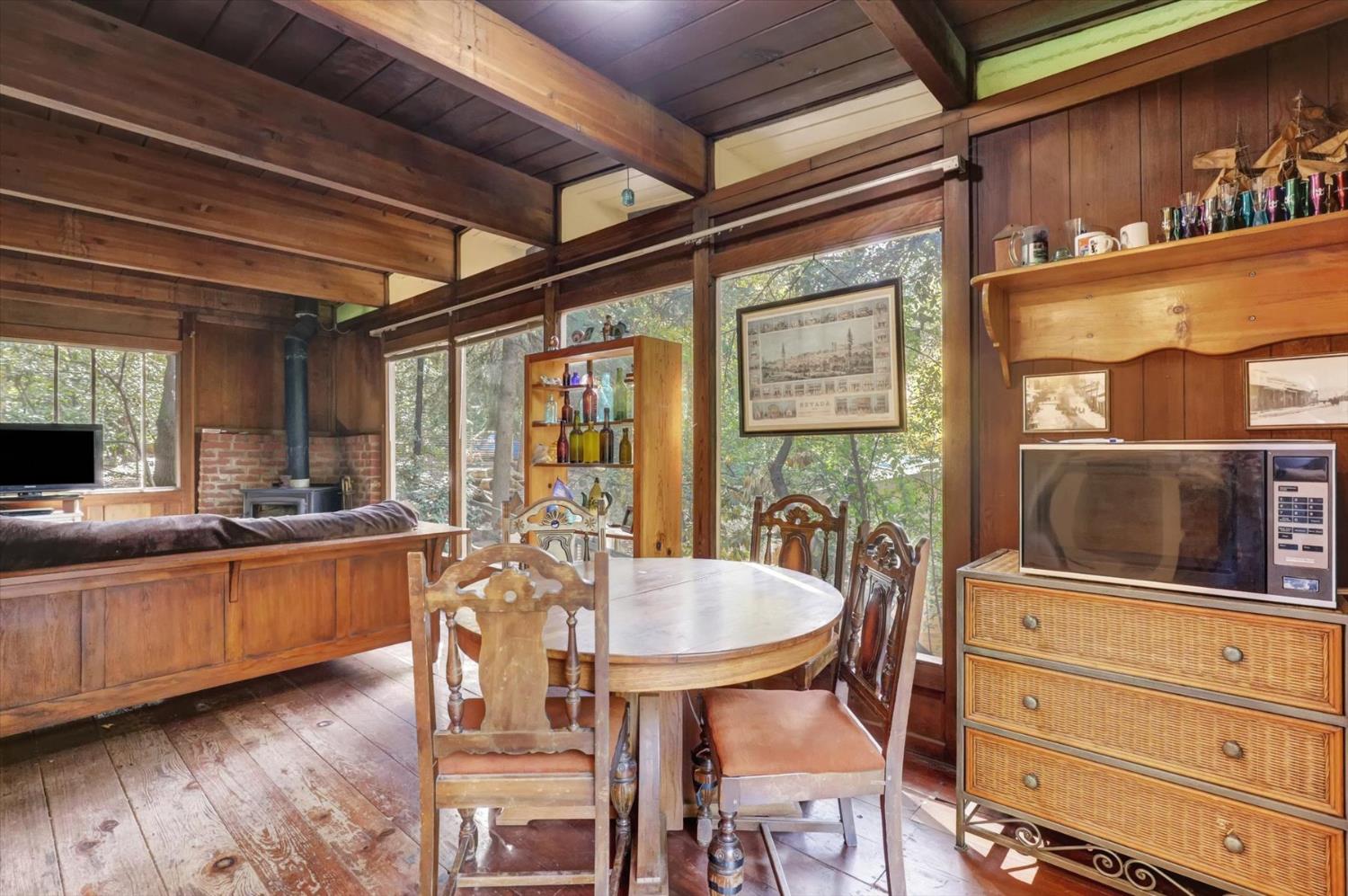 10046 Smith Road Grass Valley, CA 95949 - Photo 13 of 52 a view of a dining room with furniture window and wooden floor