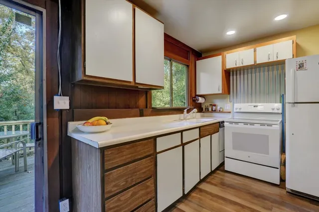 a kitchen with a sink window and cabinets