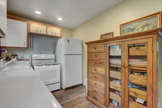 a kitchen with granite countertop cabinets and refrigerator