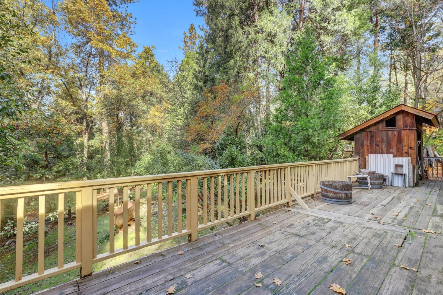 10046 Smith Road Grass Valley, CA 95949 - Photo 47 of 52 a view of a wooden deck and a yard