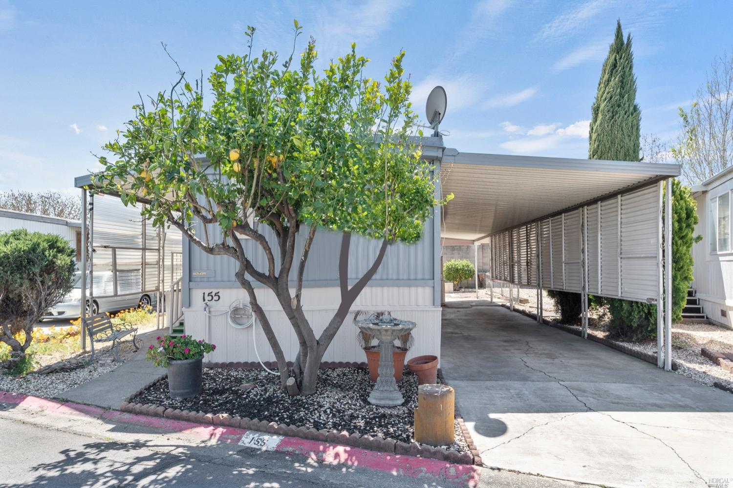 a backyard of a house with table and chairs