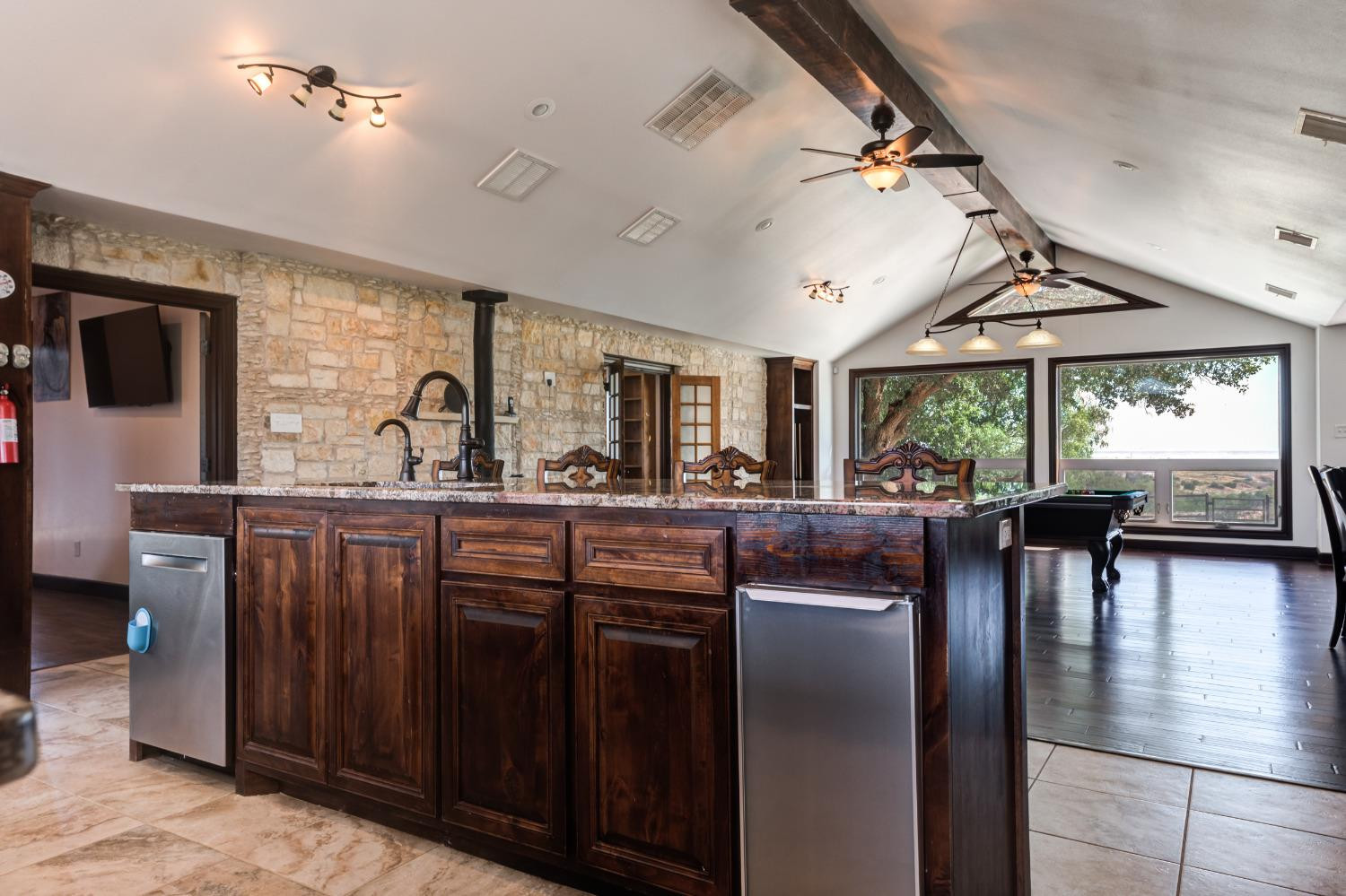 396 County Road 130 Slaton, TX 79364 - Photo 18 of 50 a kitchen with lots of counter space dining table and stainless steel appliances