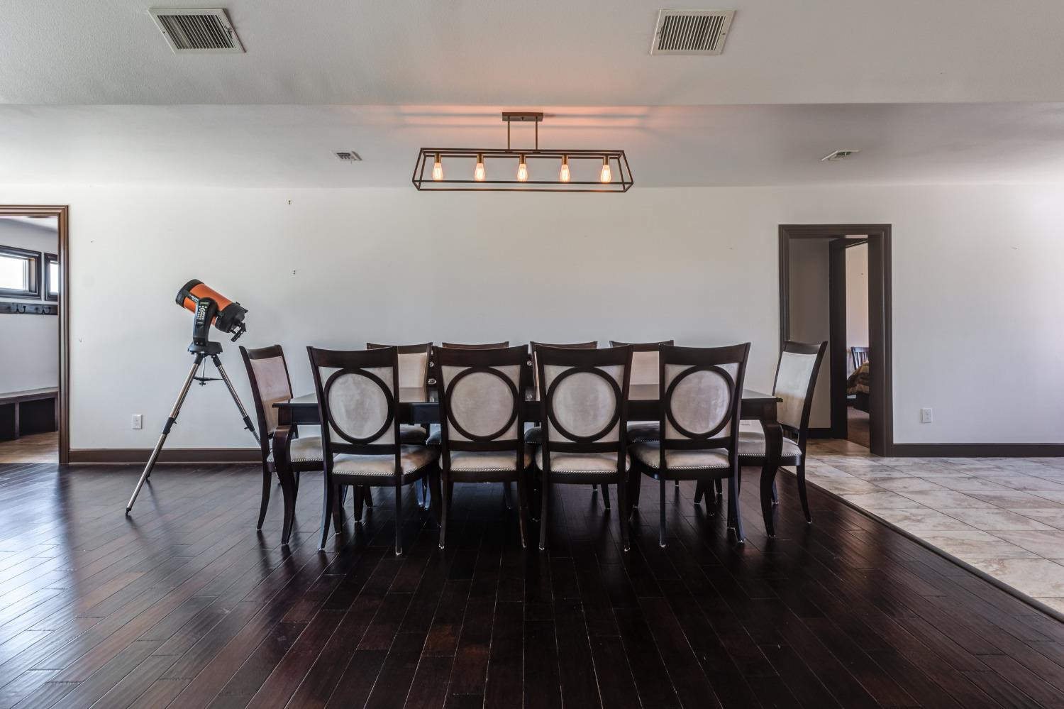 396 County Road 130 Slaton, TX 79364 - Photo 23 of 50 a view of a dining room with furniture and wooden floor