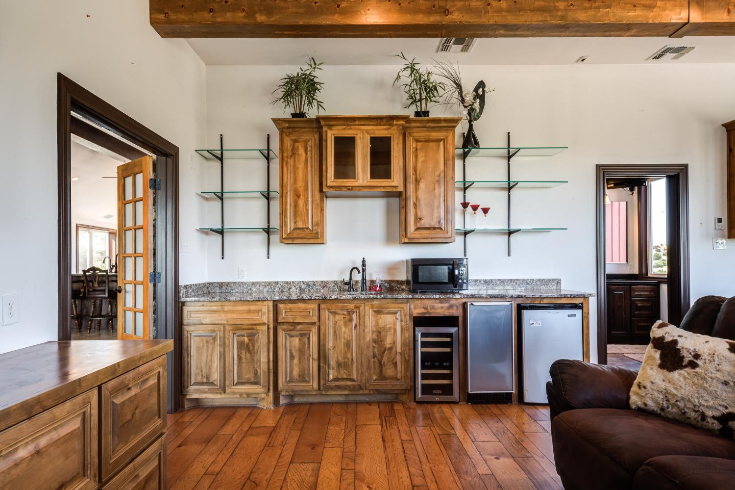 396 County Road 130 Slaton, TX 79364 - Photo 29 of 50 a kitchen with stainless steel appliances granite countertop a stove top oven a sink dishwasher a dining table and chairs with wooden floor
