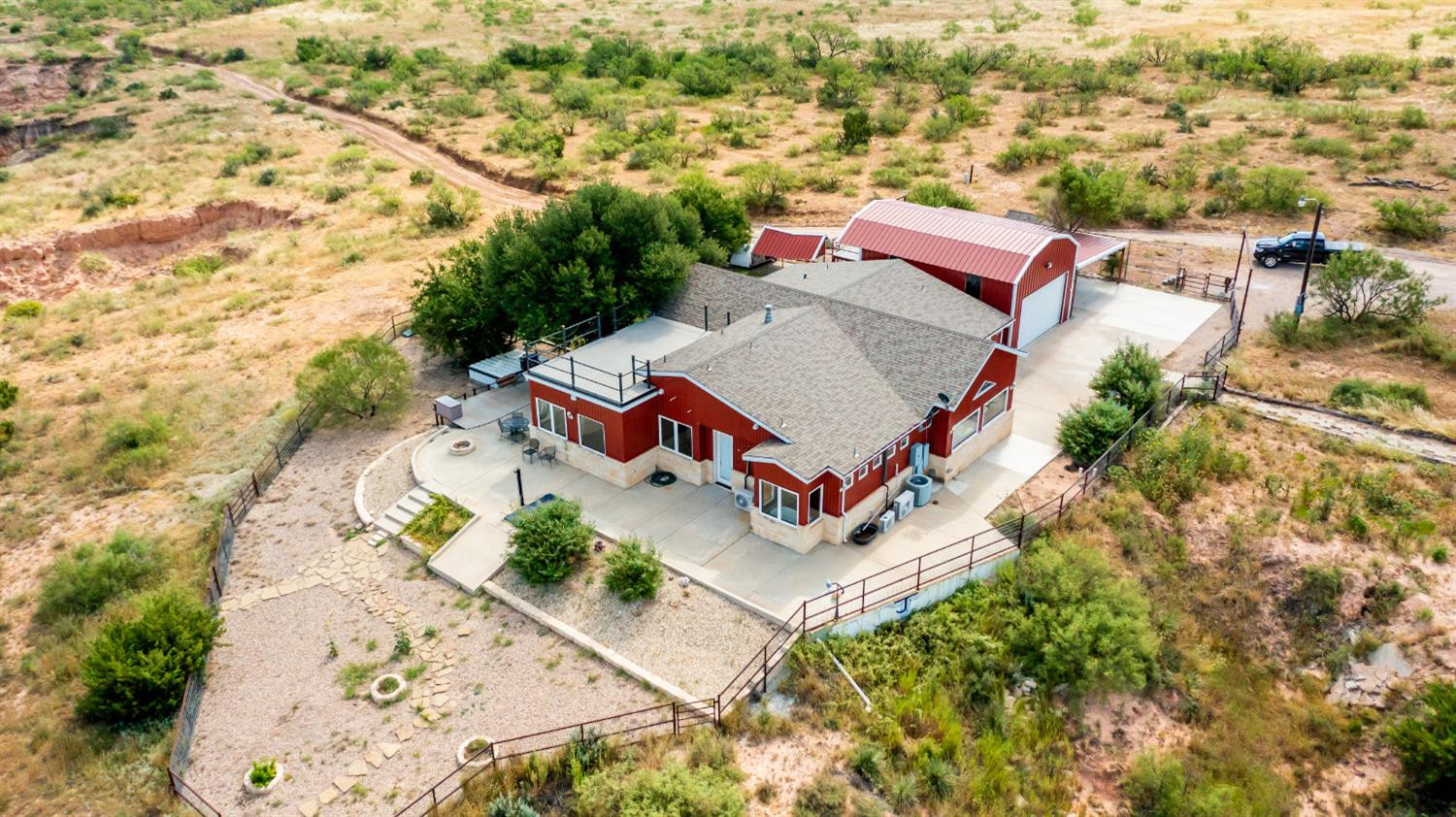 396 County Road 130 Slaton, TX 79364 - Photo 3 of 50 an aerial view of a house with a yard and trees