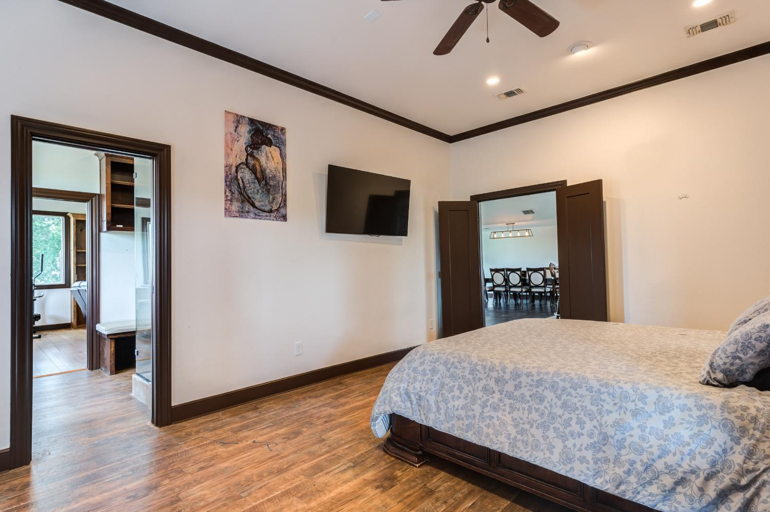 396 County Road 130 Slaton, TX 79364 - Photo 35 of 50 a bedroom with a large bed a flat tv screen and dresser
