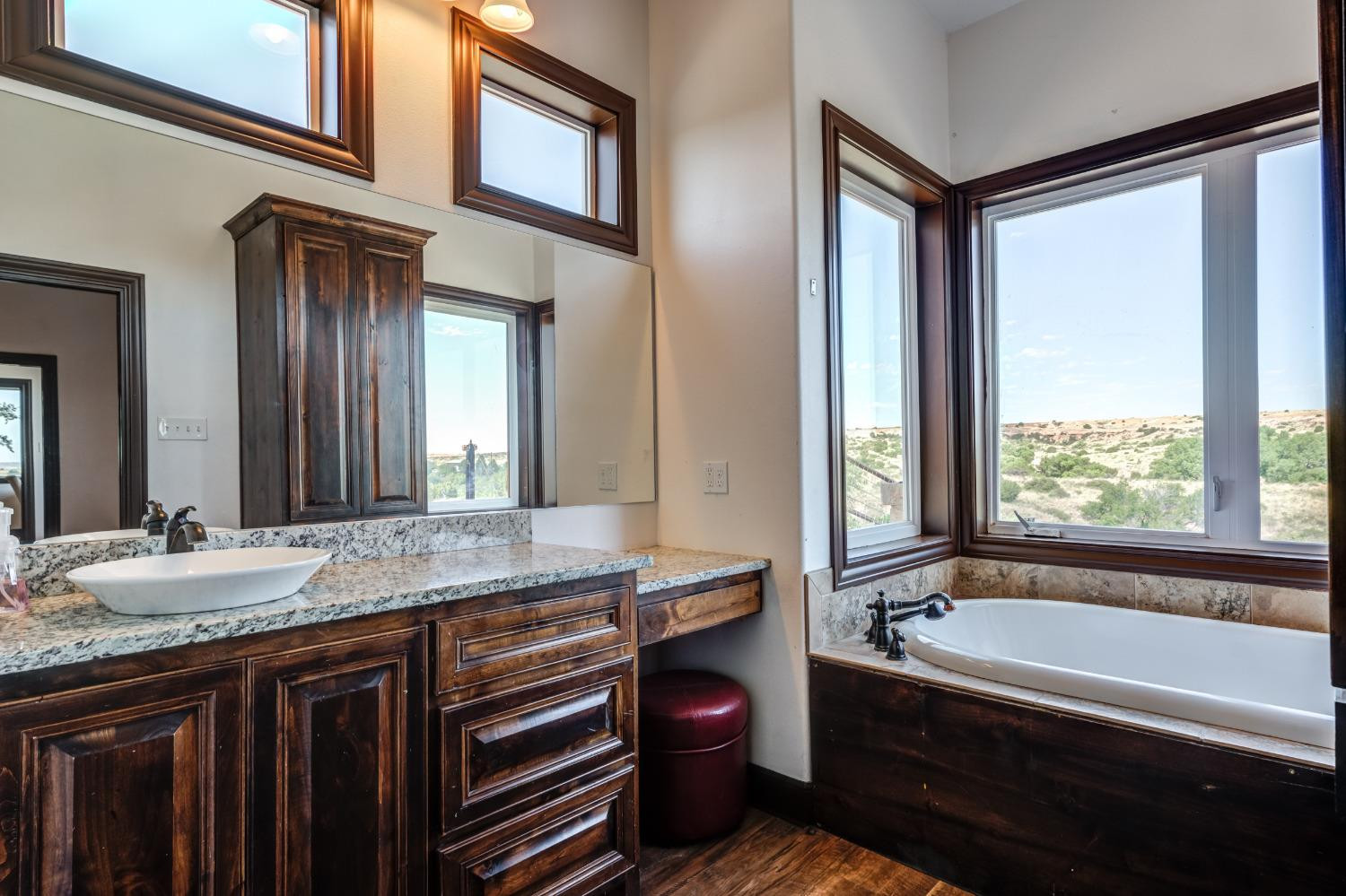 396 County Road 130 Slaton, TX 79364 - Photo 36 of 50 a bathroom with a granite countertop tub sink and mirror
