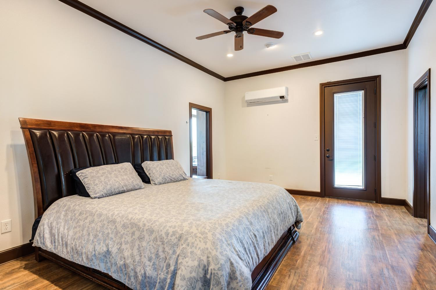 396 County Road 130 Slaton, TX 79364 - Photo 38 of 50 a bedroom with a large bed and a chandelier