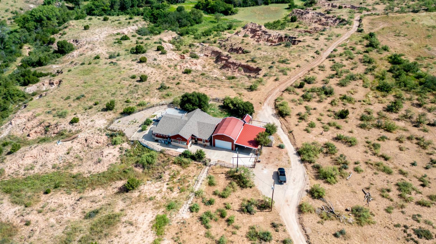 396 County Road 130 Slaton, TX 79364 - Photo 5 of 50 a aerial view of a backyard with plants and wooden fence