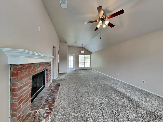 a view of an empty room with a fireplace