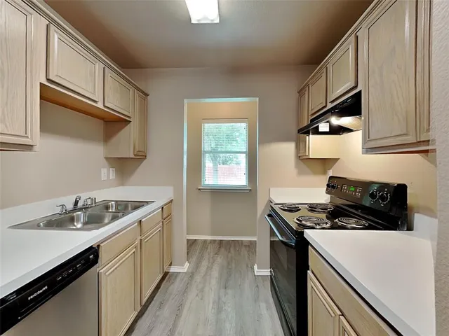 a kitchen with stainless steel appliances granite countertop a sink stove and cabinets