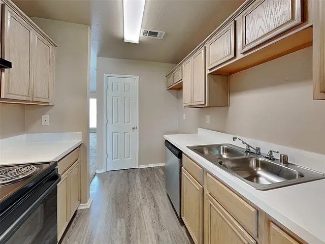 a kitchen that has a sink and a stove