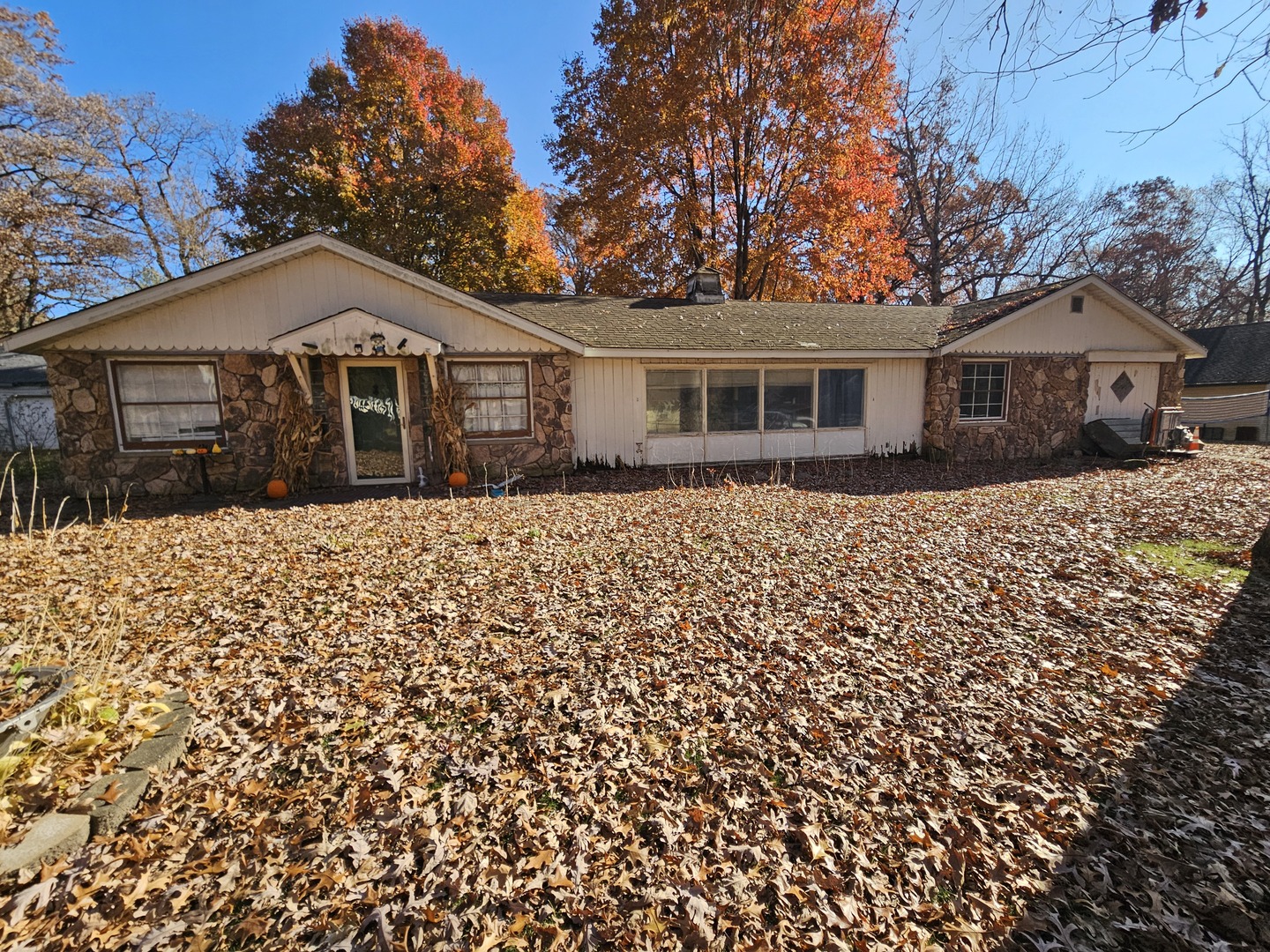 a front view of a house with a yard covered in snow