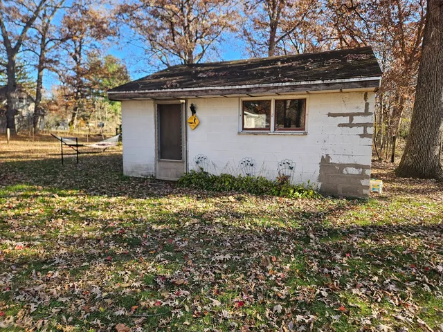 a backyard of a house with table and chairs