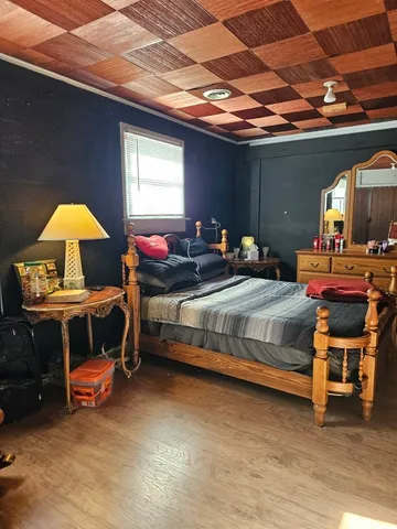 a bedroom with bed and a chandelier