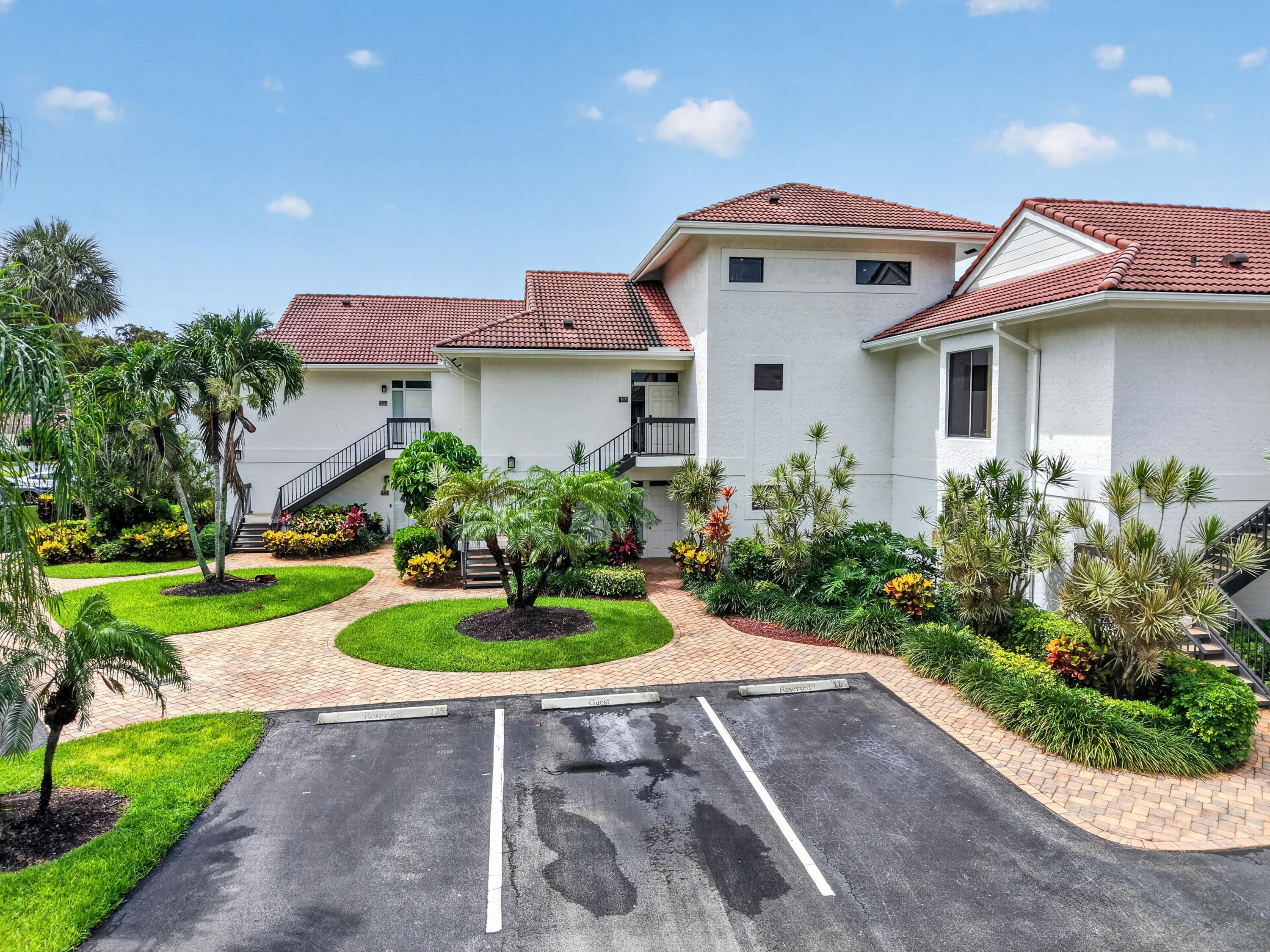 19221 Sabal Lake Drive, Unit 5124 Boca Raton, FL 33434 - Photo 45 of 98 a front view of a house with a yard and garage