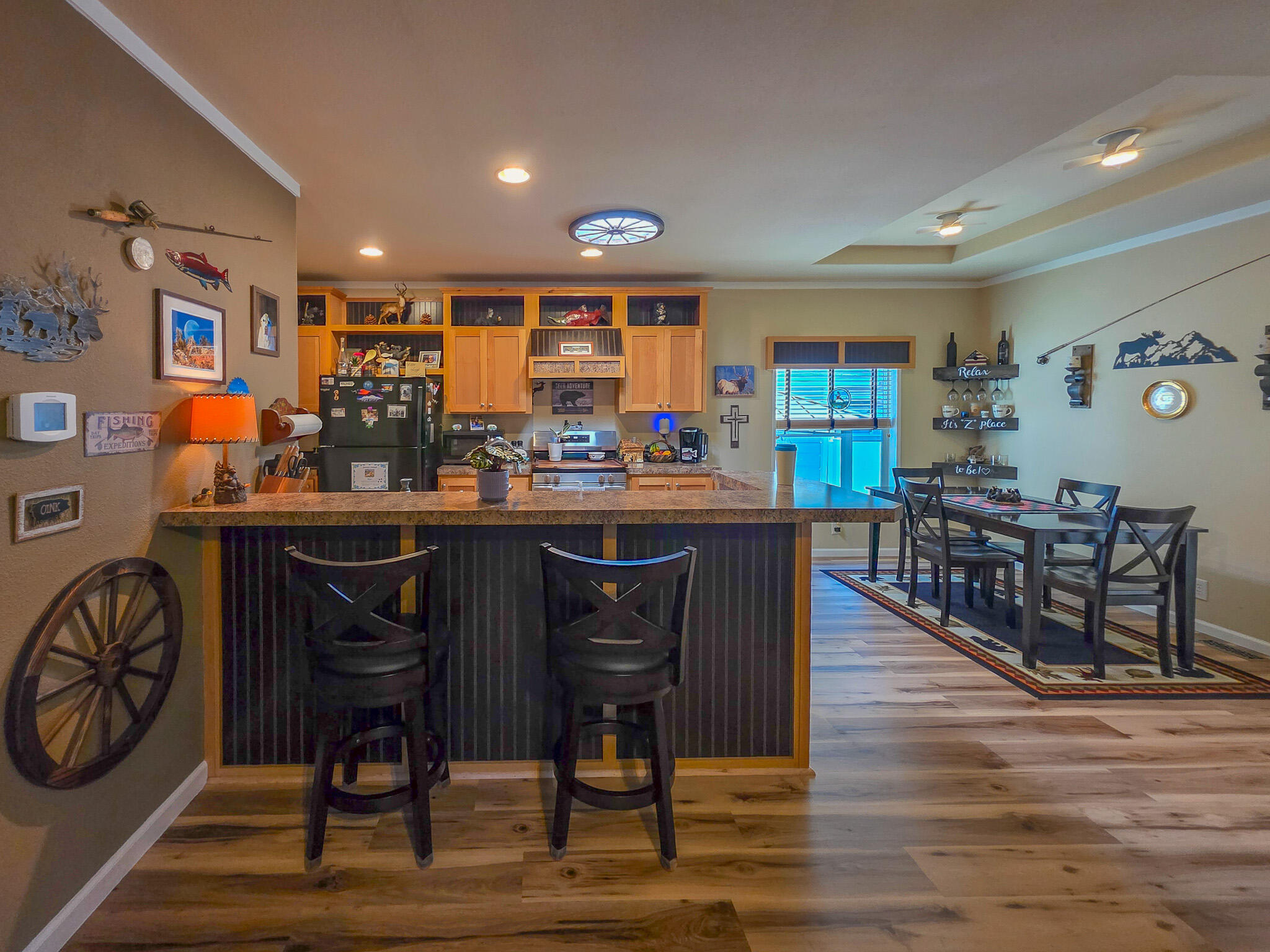 537 Thompson Creek Road, Unit 16 Jacksonville, OR 97530 - Photo 11 of 30 a dining hall with stainless steel appliances granite countertop a table and chairs