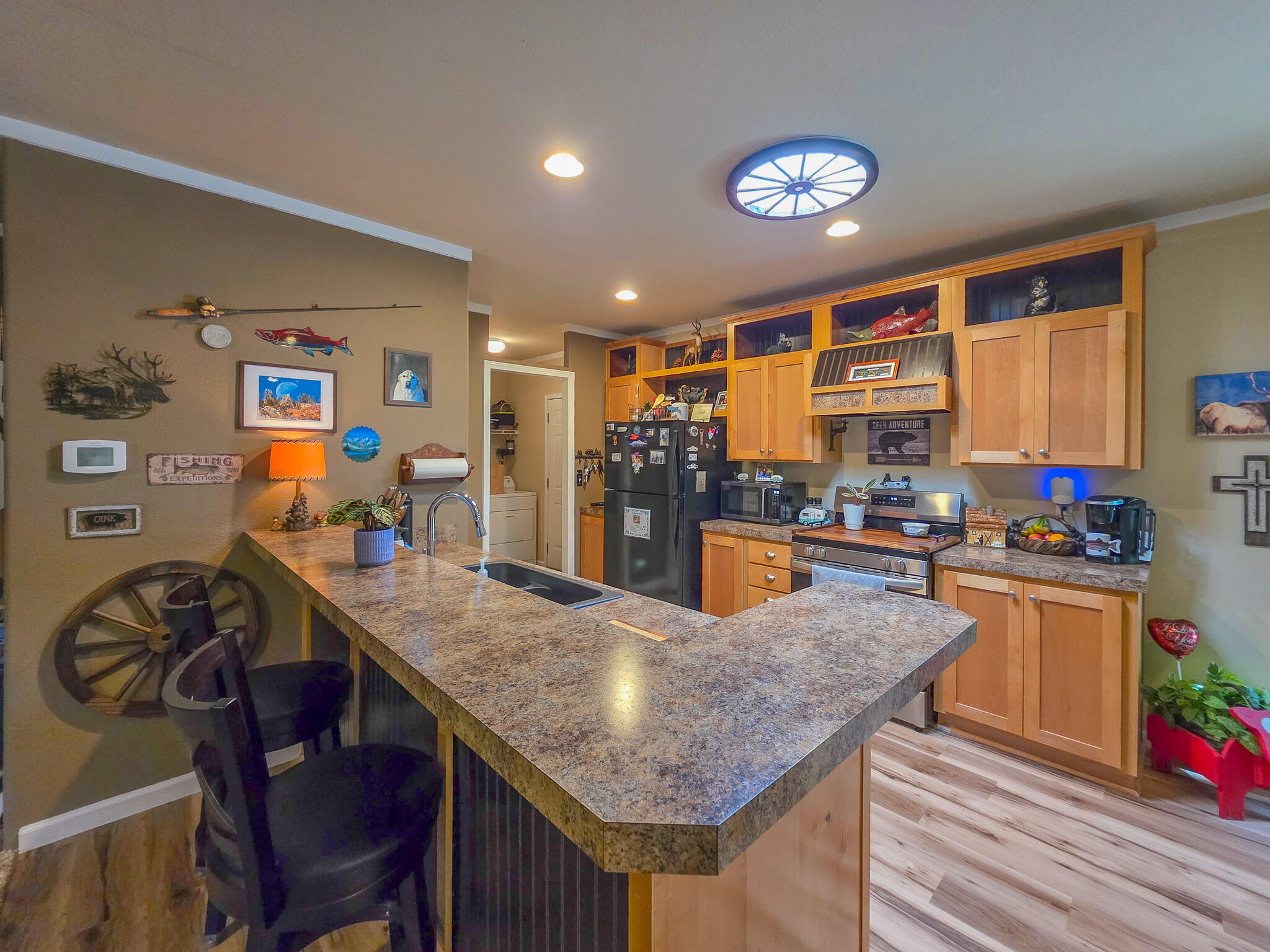 537 Thompson Creek Road, Unit 16 Jacksonville, OR 97530 - Photo 14 of 30 a kitchen with stainless steel appliances granite countertop a stove top oven a sink dishwasher and cabinets with wooden floor