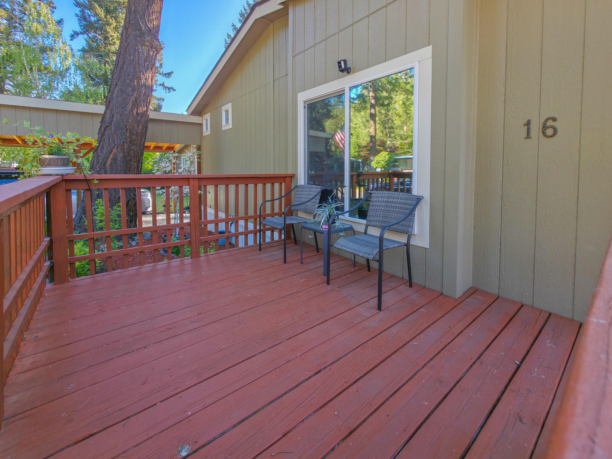 537 Thompson Creek Road, Unit 16 Jacksonville, OR 97530 - Photo 3 of 30 a balcony with wooden floor and furniture