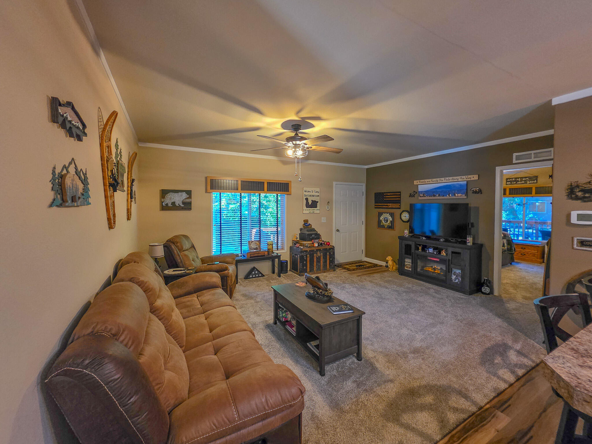 537 Thompson Creek Road, Unit 16 Jacksonville, OR 97530 - Photo 5 of 30 a living room with furniture and a flat screen tv