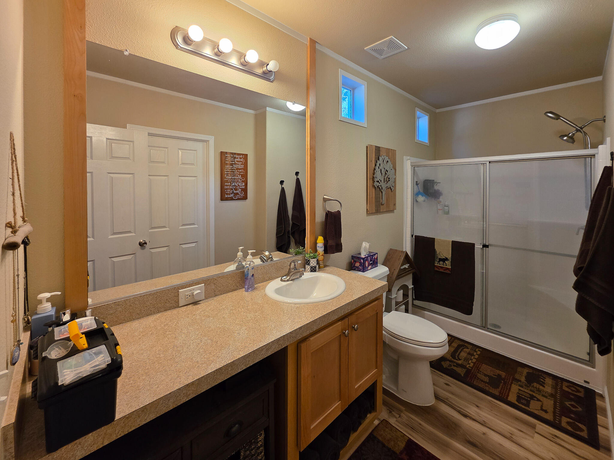 537 Thompson Creek Road, Unit 16 Jacksonville, OR 97530 - Photo 7 of 30 a bathroom with a sink a toilet a mirror and shower