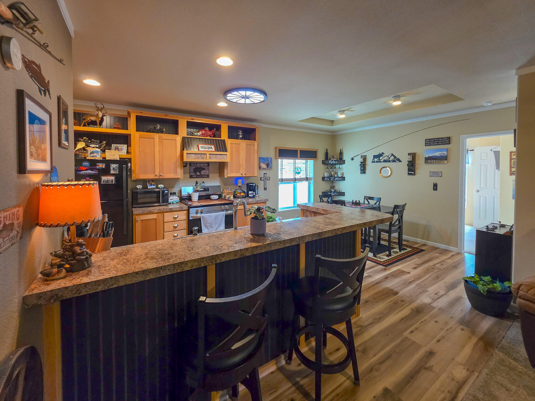 537 Thompson Creek Road, Unit 16 Jacksonville, OR 97530 - Photo 10 of 30 a kitchen with stainless steel appliances granite countertop a table chairs sink and cabinets