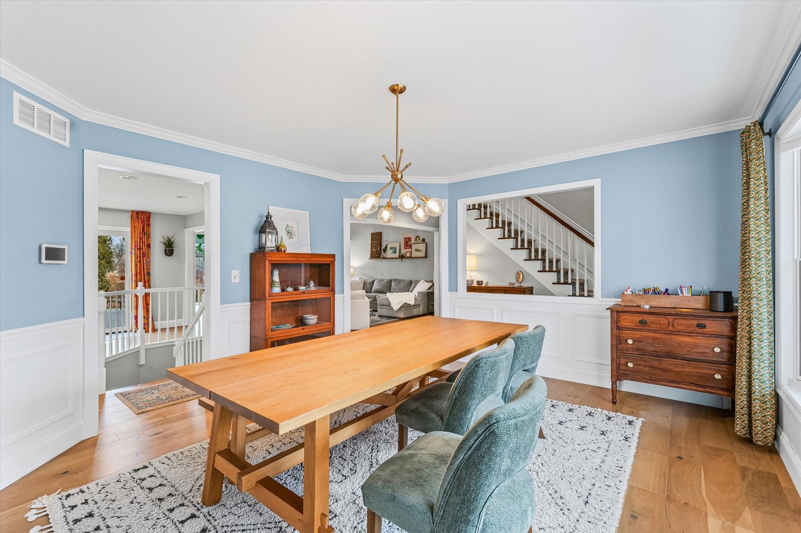 2504 Branch Road Champaign, IL 61822 - Photo 6 of 52 a dining room with wooden floor a chandelier a wooden table and chairs