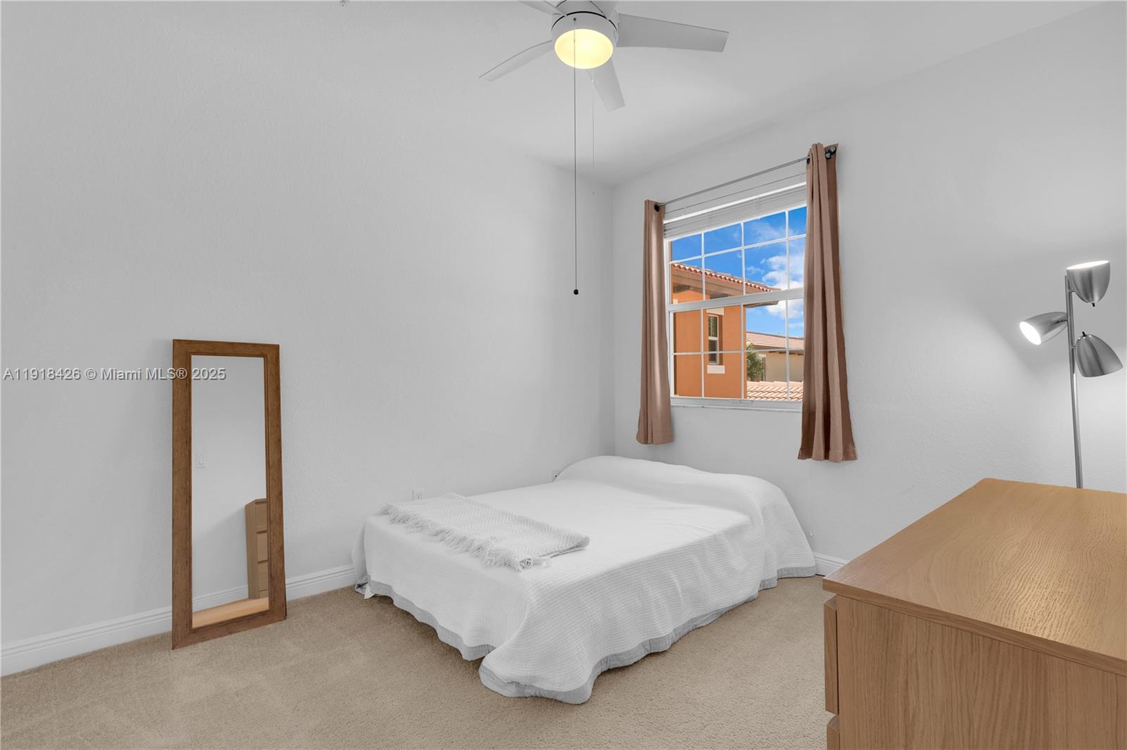 1516 Southwest 147th Avenue Pembroke Pines, FL 33027 - Photo 14 of 29 a bedroom with a bed and a lamp