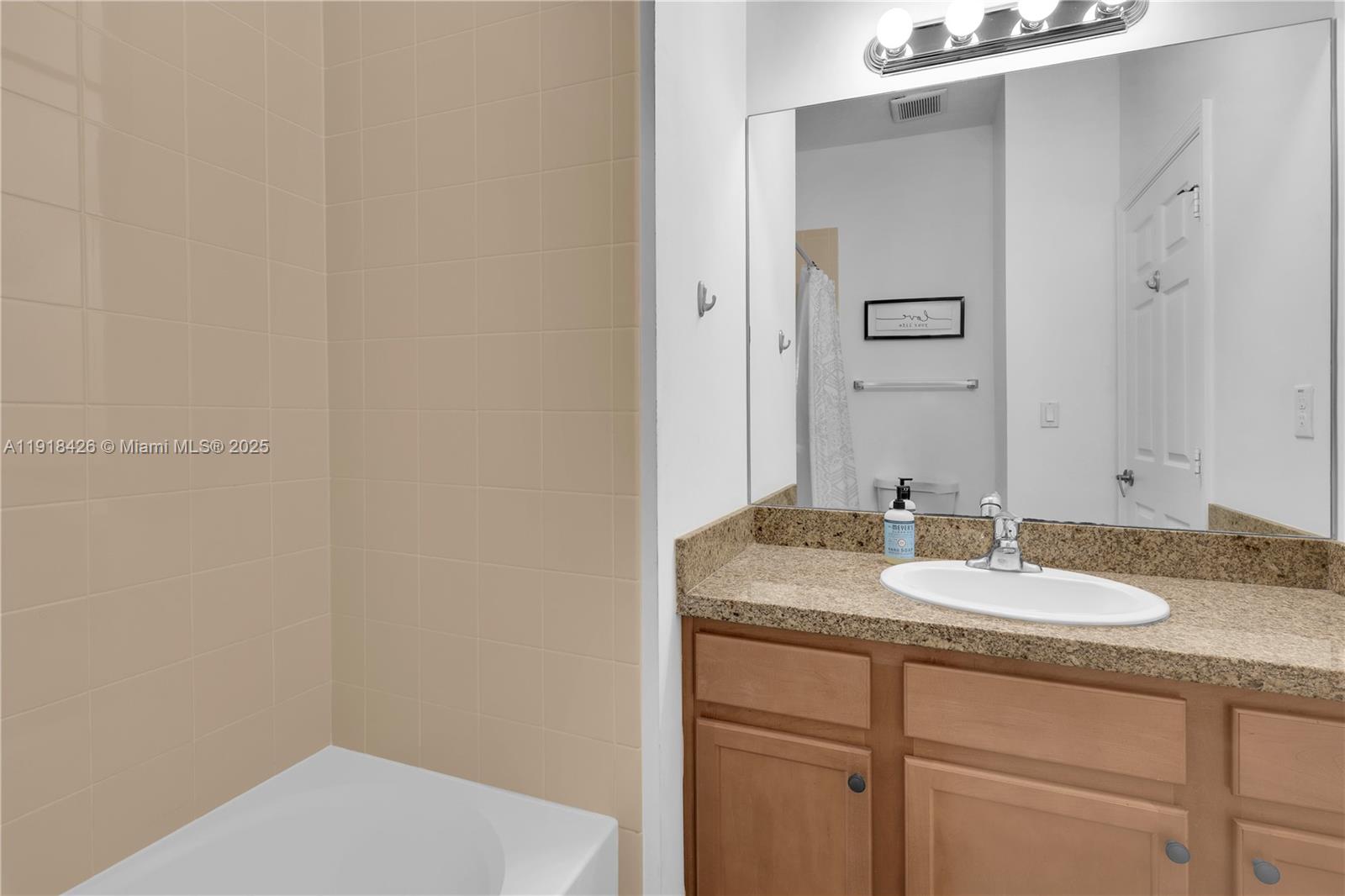 1516 Southwest 147th Avenue Pembroke Pines, FL 33027 - Photo 16 of 29 a bathroom with a granite countertop sink and a mirror