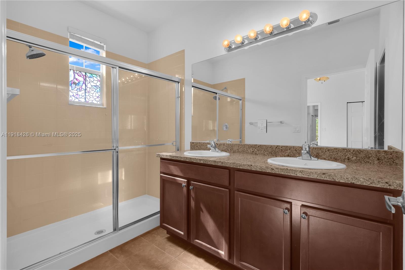 1516 Southwest 147th Avenue Pembroke Pines, FL 33027 - Photo 19 of 29 a bathroom with a granite countertop sink a mirror and a shower