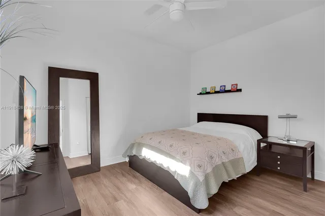 a bedroom with a bed and dresser with mirror