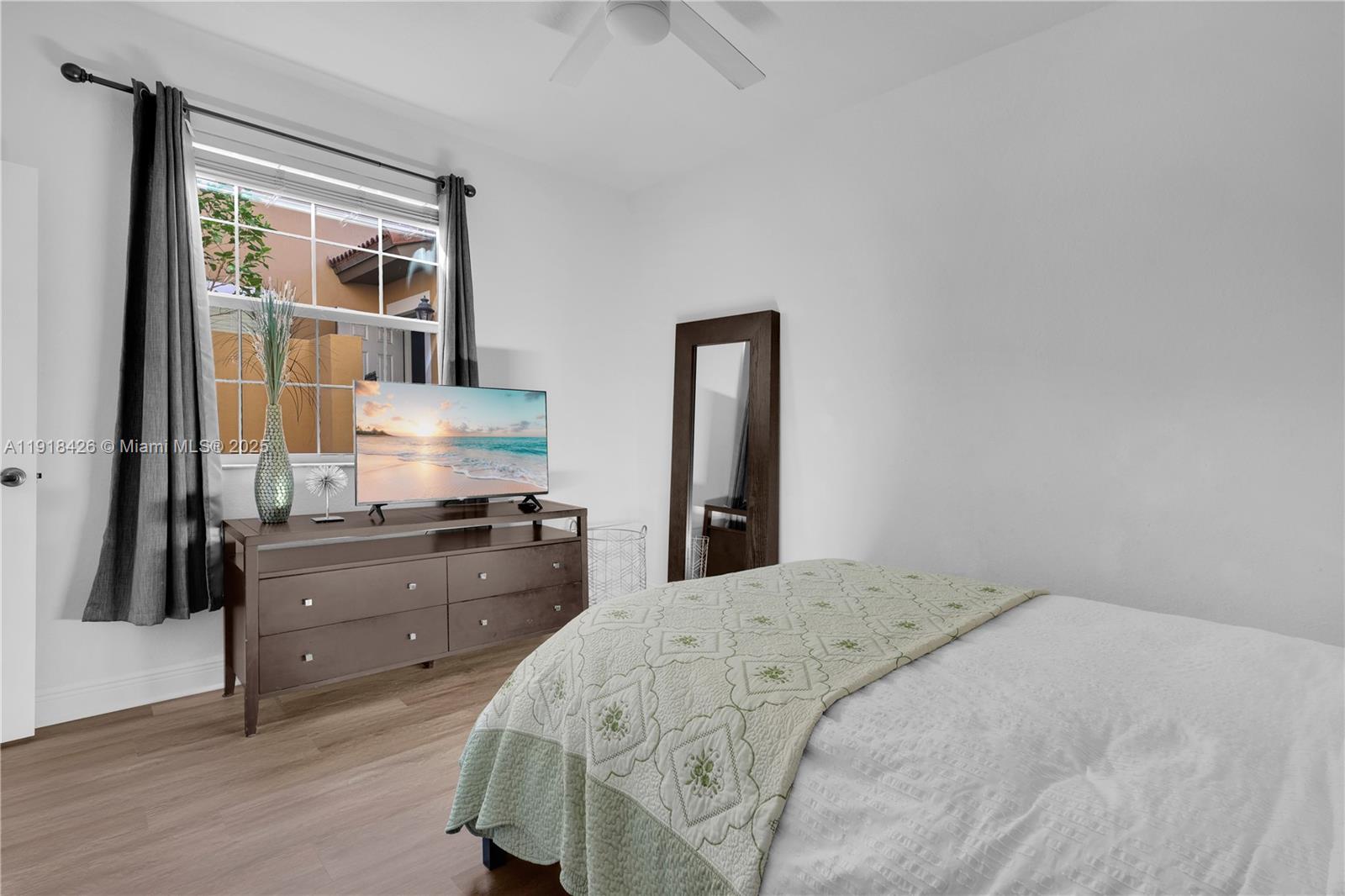 1516 Southwest 147th Avenue Pembroke Pines, FL 33027 - Photo 21 of 29 a bedroom with a bed and dresser with mirror