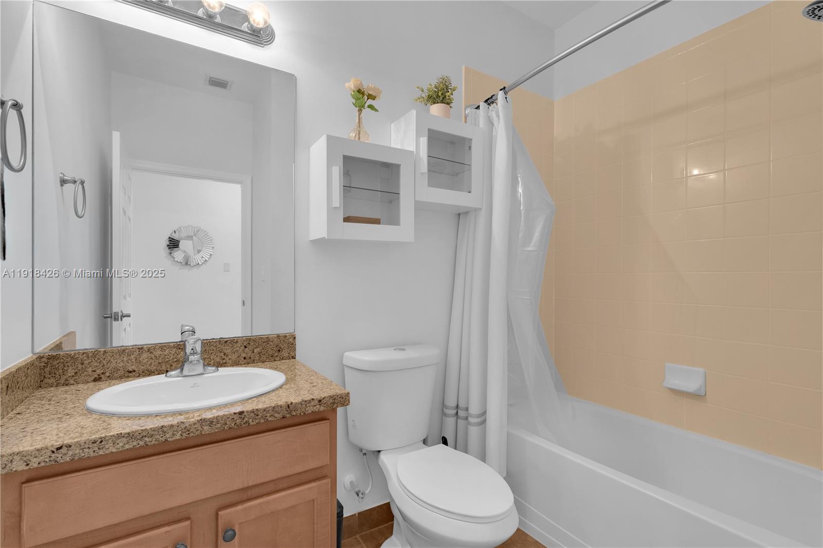 1516 Southwest 147th Avenue Pembroke Pines, FL 33027 - Photo 22 of 29 a bathroom with a granite countertop sink toilet and shower