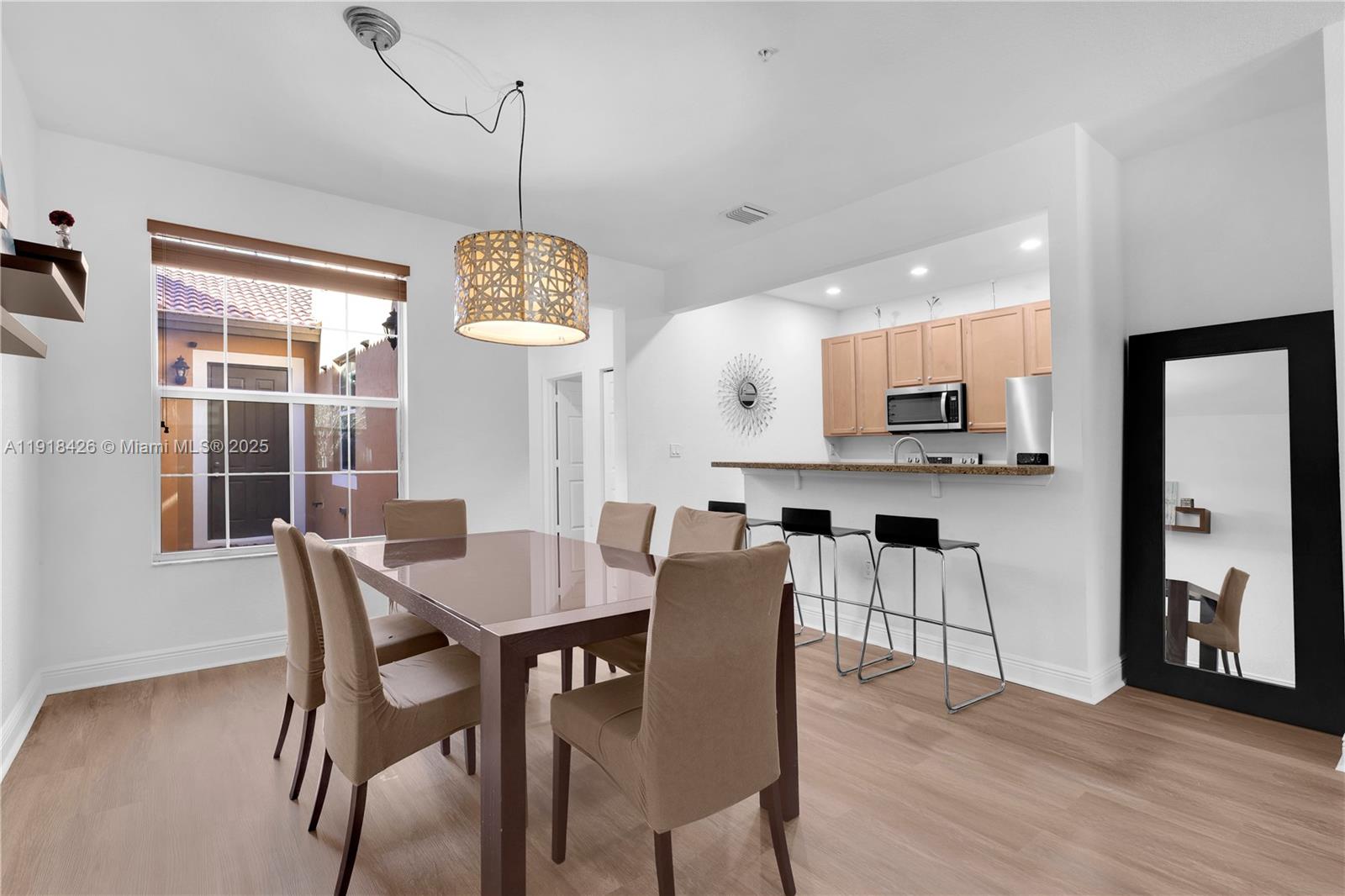 1516 Southwest 147th Avenue Pembroke Pines, FL 33027 - Photo 6 of 29 a view of a dining room with furniture window and wooden floor