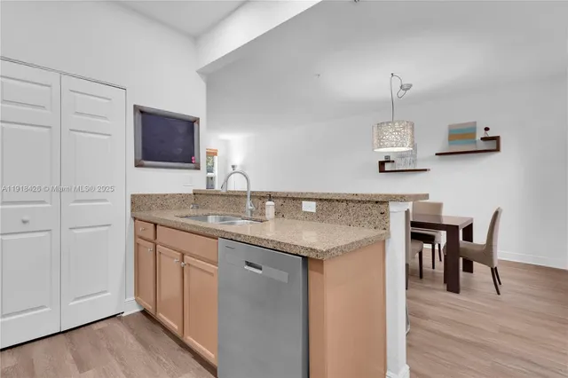 a kitchen with kitchen island stainless steel appliances a sink and stove