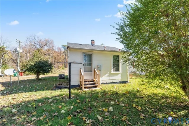 a view of a house with a yard covered in snow