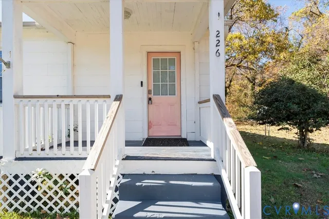 a view of a yard with plants and trees