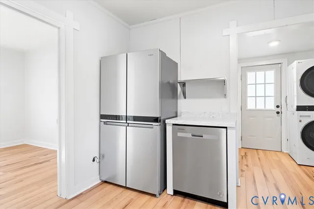 a white refrigerator freezer and a wooden floor