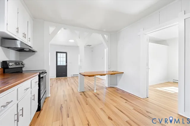 a view of a kitchen with wooden floor and a sink