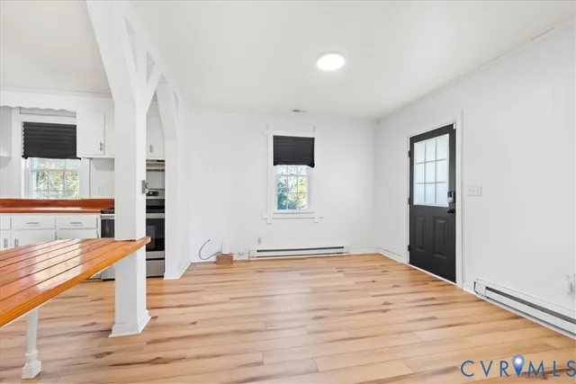 a view of a room with wooden floor and window
