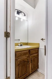 a bathroom with a granite countertop sink a mirror and a bathtub